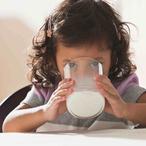 Niña pequeña tomando leche.