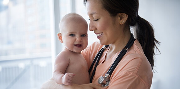 Consulta al médico cuando la tabla de peso en niños indique anomalías Bebé sonriendo con la doctora.